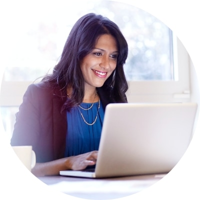 Woman smiling at her laptop